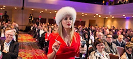 Realtor Cristina Cote in a red dress and furry hat as her alter ego "Svetty."