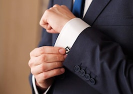 A man buttoning up his cufflinks