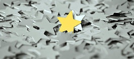 A gold star standing out in a sea of gray stars