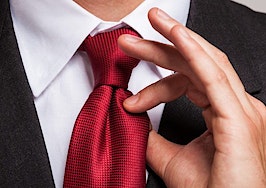 A man adjusting his necktie
