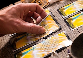 A Tarot card reader examining a spread