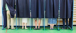 A group of people in a voting booth