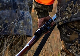 A hunter carrying a rifle