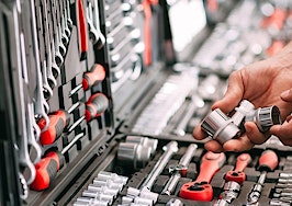 A man's hands selecting tools