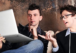 Two men on laptop computers