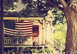An American flag in front of a home