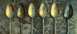 Tarnished spoons on a tarnished tray