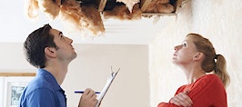 A homeowner and an inspector looking at a collapsed ceiling