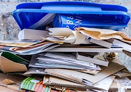 A stack of papers in a recycling bin