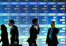 A group of people in front of a stock exchange