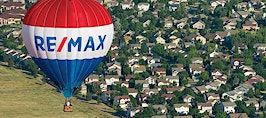 RE/MAX balloon floating over homes