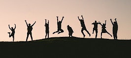 Silhouettes of people jumping