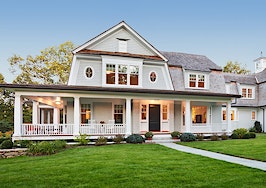 Exterior view of Custom styled home with manicured lawn and landscaping.